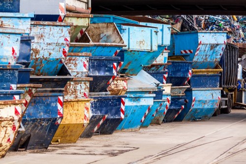 Company personnel briefing near a skip to discuss safety procedures