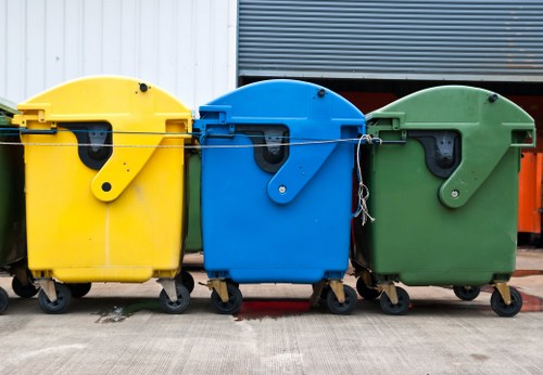 Construction workers managing waste removal site in Queens Park