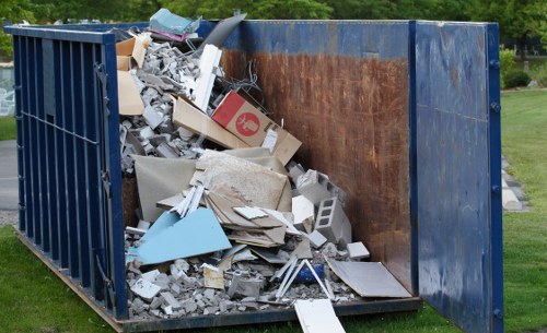 Commercial skip truck delivering to a business site in Queens Park
