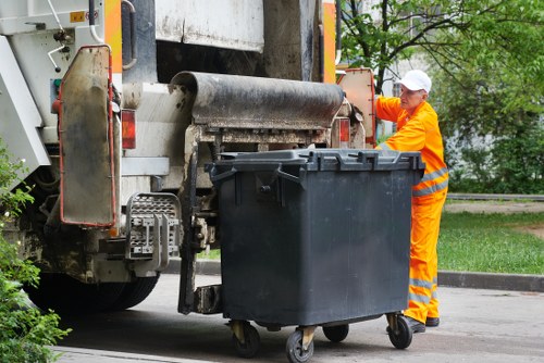 Technician inspecting a septic tank for muck buildup